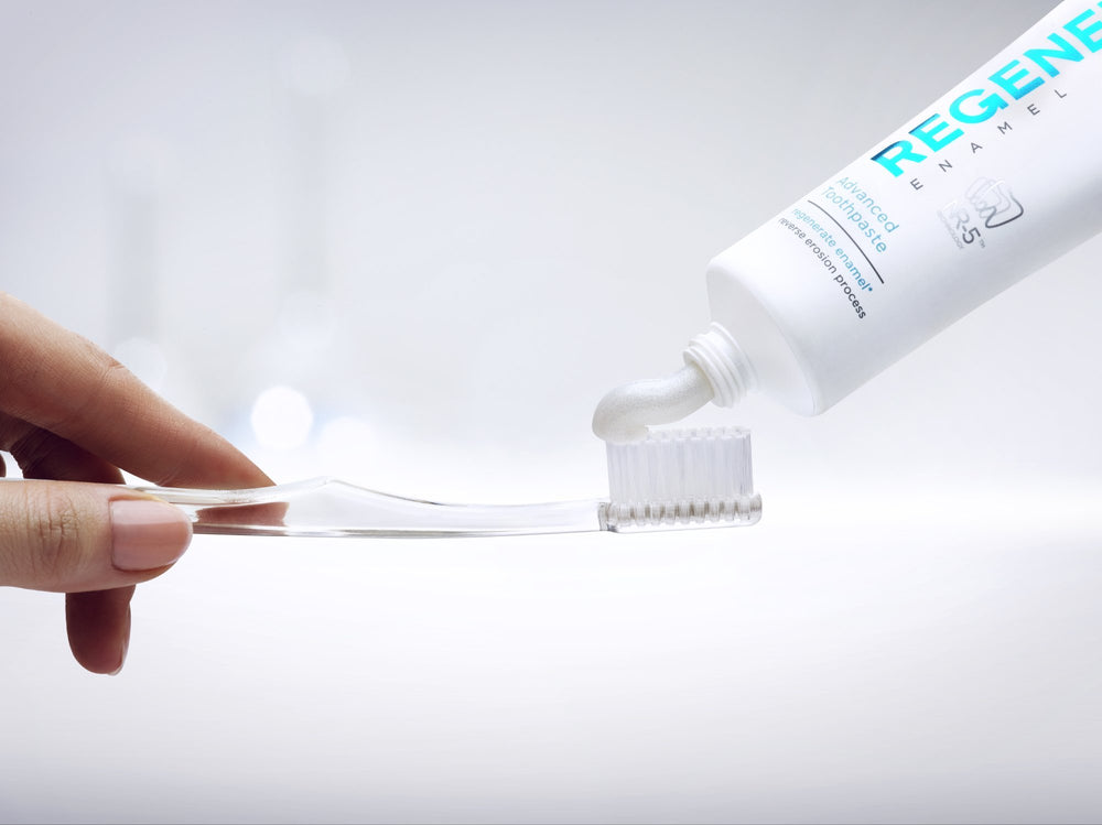 Applying Regenerate Enamel Science Toothpaste on a toothbrush